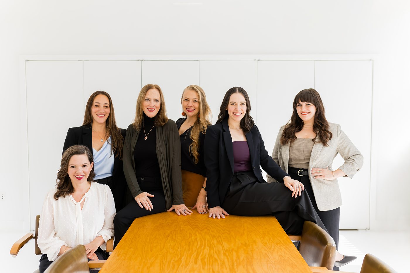 Lisa Clampitt with her matchmaking team gathered around a table in their New York office